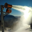Nivis Storm snow cannon producing snow on a ski slope.