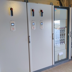 Gray electrical cabinets in a technical room.