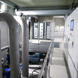 Technical room with piping and electrical cabinets.